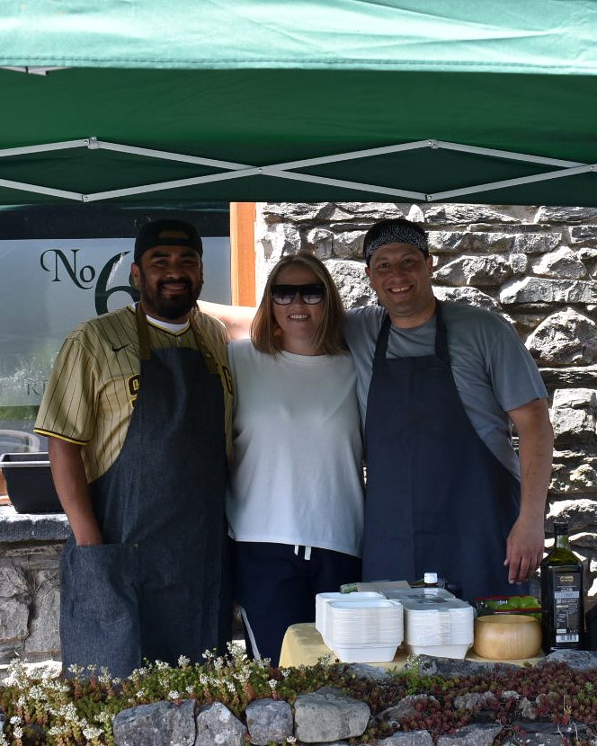The Light & Salt Provisions team serving food under a green gazebo outside The Railway Inn, Lindal-in-Furness